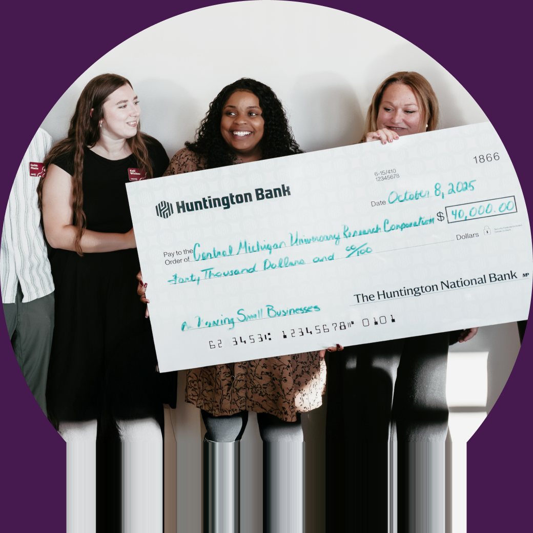 Three CMURC members holding an oversized forty-thousand-dollar Huntington Bank cheque.