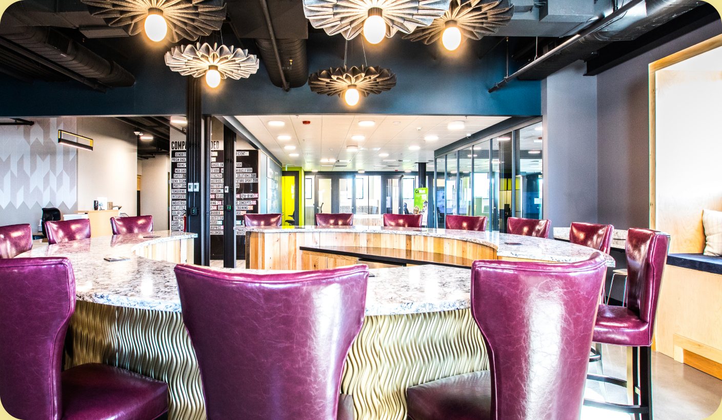 Midland coworking space: a cafe lounge with purple velvet chairs and floral pendant lights.
