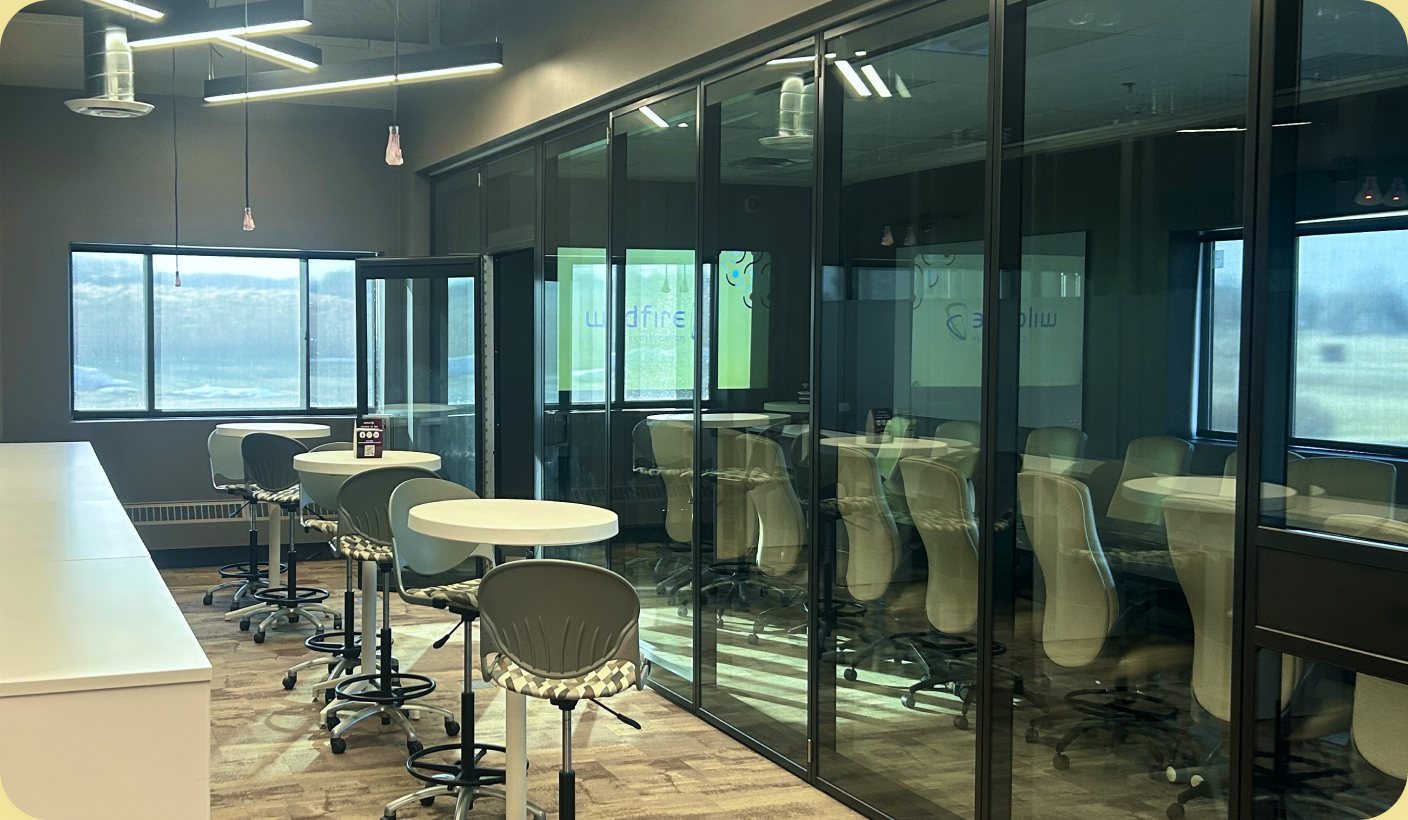 Mount Pleasant coworking space: a long room behind a glass partition wall lined with bar stools.