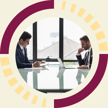 Two men in suits working across a glass boardroom table by a window, framed by the CMURC ring graphic.